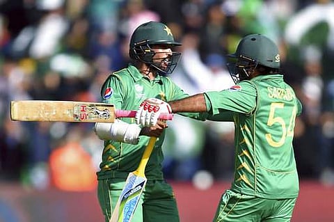 Pakistan captain Sarfraz Ahmed, right, and Mohammad Amir celebrate winning the ICC Champions Trophy, Group B cricket match | AP