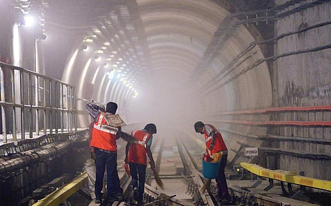 Metro workers clean the track at Majestic underground station in Bengaluru as inspection on the stretch continues | Pushkar V