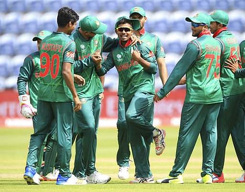 Bangladesh's Mosaddek Hossain, center, celebrates after taking the wicket of New Zealand's James Neesham during the ICC Champions Trophy. AP