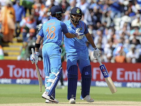 India captain Virat Kohli left congratulates India's Rohit Sharma after he reached a century during the ICC Champions Trophy semifinal match between Bangladesh and India at Edgbaston in Birmingham England Thursday June 15 2017. | AP