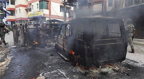 Army Personnel patrol near burning vehicles after clashes with supporters of GJM in Darjeeling on Saturday. | PTI