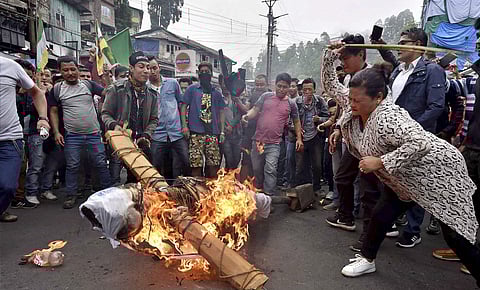 GJM supporters burn an effigy of West Bengal Chief Minister Mamata Banerjee at Chowk Bazaar during their indefinite bandh in Darjeeling on Monday. | PTI