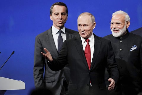Russian President Vladimir Putin gestures as he arrives to address the St. Petersburg International Economic Forum in St.Petersburg Russia Friday June 2 2017. India's Prime Minister Narendra Modi is on the right. | AP