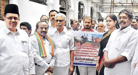 Legislators staging a walkout after CM refused to move a special resolution against Centre’s notification on cattle trade in the Assembly on Tuesday | D SAMPATHKUMAR