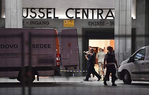 Police investigators and members of the DOVO (bomb clearing squad) work inside Central Station in Brussels after a reported explosion on Tuesday, June 20, 2017. | AP