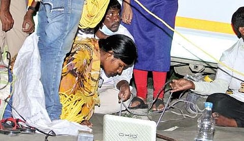 Renuka, mother of Chinnari, looks into the borewell where her daughter accidentally fell down. | Express Photo Service