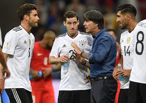 Germany coach Joachim Loew, second right, talks to players Jonas Hector, Sebastian Rudy and Emre Can, from left, in a break during the Confederations Cup, Group B soccer match between Germany and Chile, at the Kazan Arena. | AP