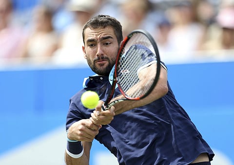 Croatia's Marin Cilic plays a return to USA's Donald Young during day five of the Queen's Club tennis tournament in London. | AP