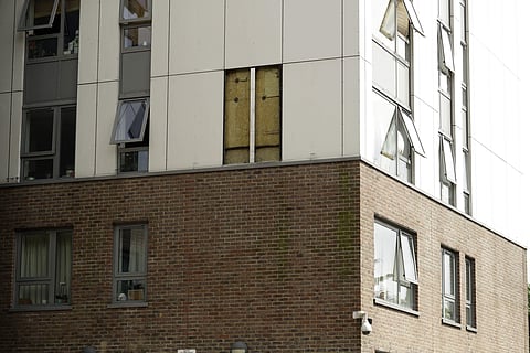 A view of part of the Burnham residential tower on the Chalcots Estate showing the bottom section of the building after cladding was removed, in the borough of Camden, north London. (File photo | AP)