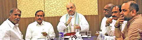 Visiting BJP national president Amit Shah (centre) with former Chief Minister N Rangasamy (left) in Puducherry on Monday | G PATTABIRAMAN