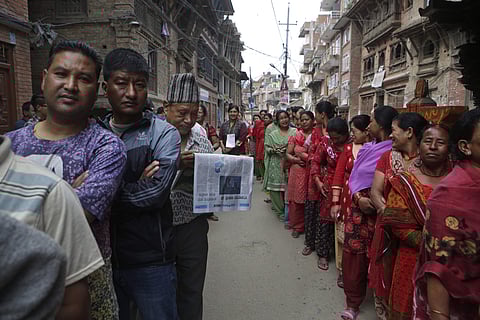 Nepalese stand in a queue to cast their votes at a polling station during the local election in Bhaktapur, Nepal. (File photo | AP)