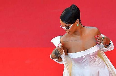 Barbadian singer Rihanna poses as she arrives on May 19, 2017 for the screening of the film 'Okja' at the 70th edition of the Cannes Film Festival in Cannes, southern France. | AFP