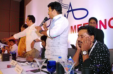 Actor Dileep in a pensive mood while other office-bearers of AMMA, including Ganesh Kumar MLA, Innocent MP and Devan, argue with mediapersons during the press briefing after the AMMA general body meet in Kochi on Thursday | K Shijith