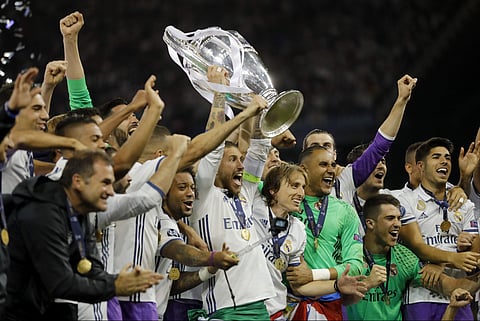 Real Madrid captain Sergio Ramos raises the trophy after the Champions League final soccer match between Juventus and Real Madrid at the Millennium stadium in Cardiff, Wales. (AP)