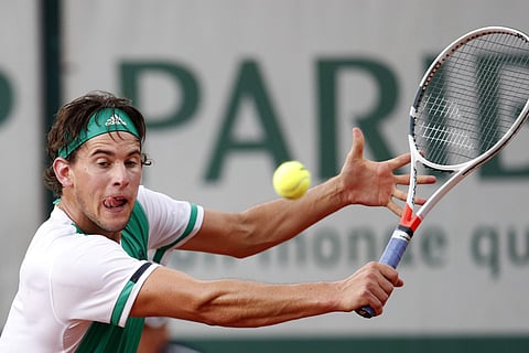 Austria's Dominic Thiem plays a shot against Steve Johnson of the U.S. during their third round match of the French Open tennis tournament at the Roland Garros stadium. | AP