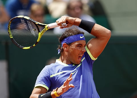 Spain's Rafael Nadal returns the ball to compatriot Roberto Bautista Agut during their fourth round match of the French Open tennis tournament at the Roland Garros stadium. | AP