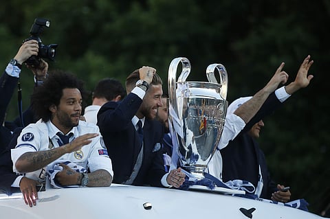 Real Madrid players arrive on an open-topped bus to Cibeles square to celebrate after winning the Champions League final, Madrid, Spain. | AP