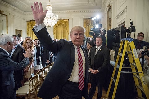 President Donald Trump waves as he departs an Air Traffic Control Reform Initiative event in the East Room at the White House, Monday, June 5, 2017, in Washington. | AP