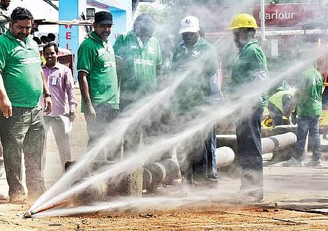 Officials testing the newly launched mini sewer jetting machines on the Necklace road in Hyderabad on Monday| Vinay Madapu