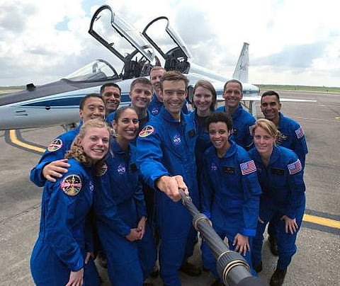 In this photo obtained from NASA, the 2017 NASA astronaut candidates stop to take a group photo while getting fitted for flight suits at Ellington Field near NASA’s Johnson Space Center in Houston, Texas, on June 7, 2017. | AFP