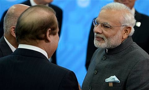 Narendra Modi, right, speaks to Prime Minister of Pakistan Nawaz Sharif, back to a camera, during the SCO (Shanghai Cooperation Organization) summit in Ufa, Russia, on July 10, 2015. (Host photo agency/RIA Novosti Pool)