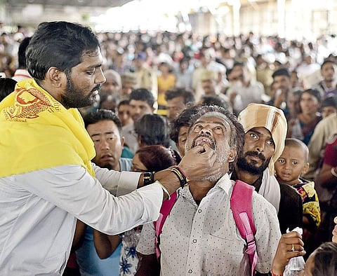 A volunteer administers ‘fish prasadam’ to an asthma patient in Hyderabad on Thursday,