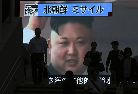 In this Tuesday, July 4, 2017, file photo, people walk past a TV news showing an image of North Korean leader Kim Jong Un while reporting North Korea's missile test which landed in the waters of Japan's economic zone (EEZ) in Tokyo. (Associated Press)