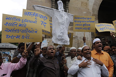 Placards read, 'God killed terrorists for the peace in the world', left 'tribute by Muslims community to the victims of Amarnath pilgrimage' second right and ' Pakistan down down'. | AP