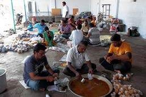 Amudhasurabi volunteers gathered at the kitchen pack food items to be served for destitute in the city and rural areas around Salem town | Express