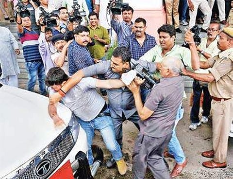 Bihar deputy chief minister Tejaswi Yadav’s security personnel manhandle a media person in Patna on Wednesday| PTI
