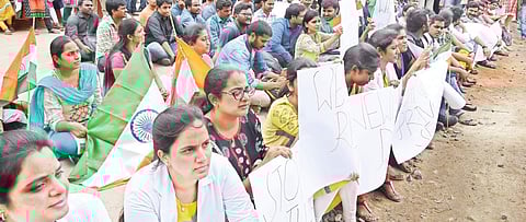 Siddhartha Medical College students stage protest demanding cancellation of senior resident-ship and against GO MS99 in Vijayawada on Wednesday (EPS |R V K Rao)