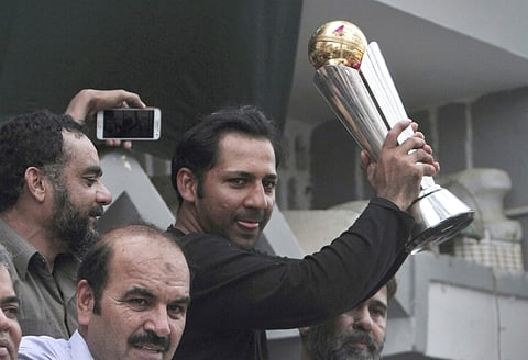 FILE - In this June 20, 2017 file photo, Pakistani cricket team's skipper Sarfraz Ahmed raises Champions Trophy for a crowd gathered to welcome him, outside his residence in Karachi, Pakistan. The Pakistan Cricket Board on Tuesday, July 4, 2017, appointed