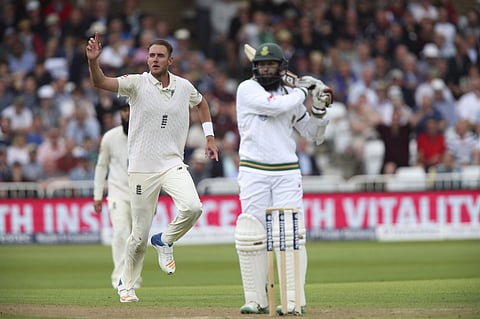 England's Stuart Broad, left, celebrates dismissing South Africa's Hashim Amla during day one of the second cricket Test match between England and South Africa. | AP