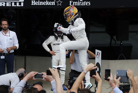 Mercedes driver Lewis Hamilton of Britain celebrates after winning during the British Formula One Grand Prix at the Silverstone racetrack in Silverstone, England, Sunday, July 16, 2017. | AP