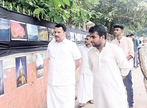 Congress leader K Muraleedharan takes a look at the photographs B P Deepu