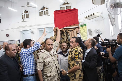 Men carry the coffin of a soldier, who was killed a day earlier in the restive Sinai Peninsula, during a funeral ceremony in the 10th of Ramadan city, about 60 kms north of Cairo, on Saturday. | AP