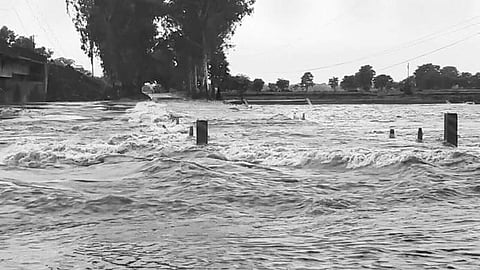 Flood water of Hati river flowing on a road near Junagarh in Kalahandi | Express