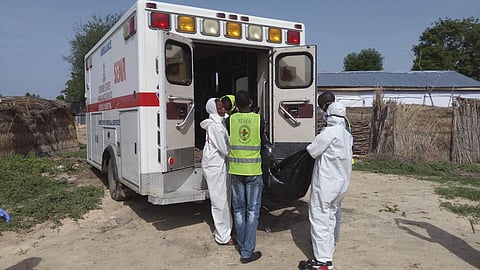 Rescue workers load a body into an ambulance following a suicide bomb attack in Maiduguri on July 17. | AP
