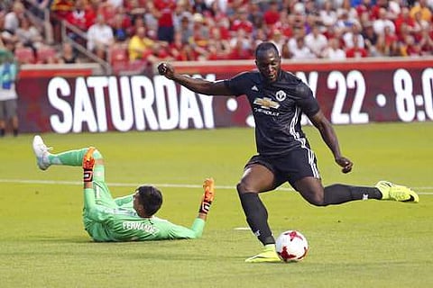 Manchester United forward Romelu Lukaku, right, scores against Real Salt Lake goalkeeper Lalo Fernandez during the first half of a friendly soccer match. | AP