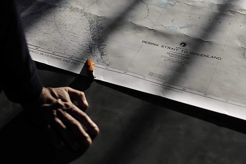 Polar maritime lawyer Scott Joblin, from the Australian National University in Cambria, looks over a map aboard the Finnish icebreaker MSV Nordica as it sets sail in the North Pacific Ocean toward the Bering Strait, Thursday, July 6, 2017. (Associated Pre