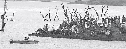 Police, Fire and Rescue Services personnel and local residents carrying out search operations for the missing persons at Banasura Sagar dam in Wayanad on Monday | Express