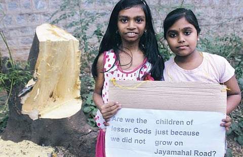 Schoolchildren holding placards against chopping of trees | S Manjunath
