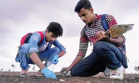 A team from New Delhi collects soil samples in Antur near Gadag on Wednesday
