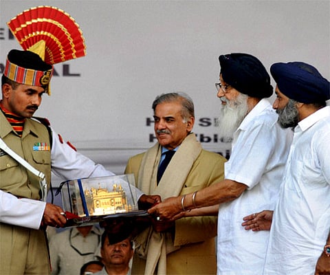 Pakistan's Punjab Chief Minister Shehbaz Sharif (centre) being presented a memento by Punjab CM Parkash Singh Badal. (File Photo: PTI)