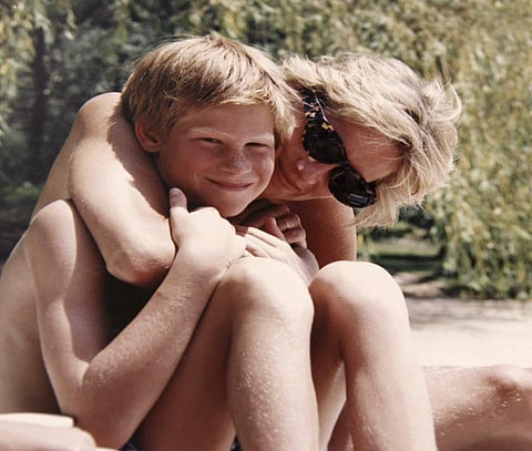 In this photo made available by Kensington Palace from the personal photo album of the late Diana, Princess of Wales, shows the princess and Prince Harry on holiday, and features in the new ITV documentary 'Diana, Our Mother: Her Life and Legacy.' (AP)