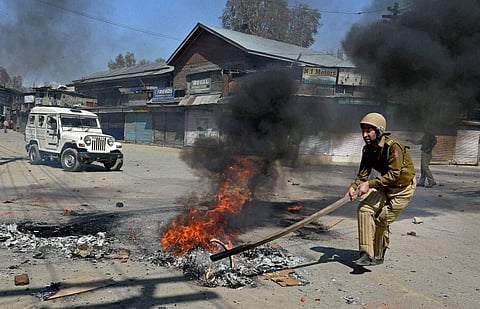 Protesters throw stones on police during a protest against government's plan for setting up separate township for Kashmiri Pandits, at Lal Chowk in Srinagar. (PTI Photo)