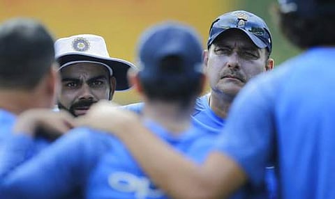 India's cricket captain Virat Kohli, second left, speaks to his team members as coach Ravi Shastri watches before the beginning of a warm up game with Sri Lanka's Board XI in Colombo|AP