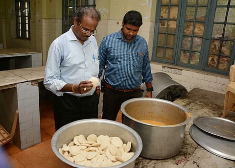 Food safety officials inspecting the idlies in which students allegedly found a lizard at the hostel of Quaid-e-Millath College for Women, on Monday | Express