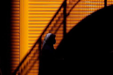 An Indonesian woman walking along a street in the Causeway Bay district of Hong Kong on a Sunday when most of the city's domestic helpers get the day off. (Photo | AFP)