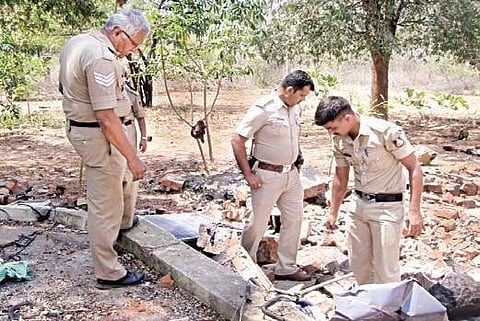 Police officials looking at a demolished anti-poaching camp in Sangam Range, in March 2017. (Express Photo)